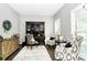 Bright office space with hardwood floors, built-in shelves, and two accent chairs at 516 Aspen Ln, Indian Trail, NC 28079