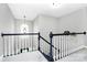 Upstairs hallway with staircase overlooking downstairs and natural light at 516 Aspen Ln, Indian Trail, NC 28079