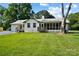 This home features a large backyard, screened in patio and a manicured lawn at 5428 Barnsdale Ln, Mint Hill, NC 28227