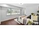 Serene bedroom with a large window, plush bedding, and hardwood floors at 5428 Barnsdale Ln, Mint Hill, NC 28227