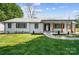 Charming ranch-style home with a well-manicured lawn, a painted brick facade, and updated wooden porch columns at 5428 Barnsdale Ln, Mint Hill, NC 28227