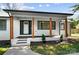 Inviting front porch features natural wood posts, black trim, and stylish landscaping, providing curb appeal at 5428 Barnsdale Ln, Mint Hill, NC 28227