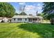 Traditional home with a well-kept lawn and an American flag displayed in the front yard at 5428 Barnsdale Ln, Mint Hill, NC 28227