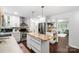 Modern kitchen with granite countertops, stainless steel appliances, island, and seamless flow to the adjacent rooms at 5428 Barnsdale Ln, Mint Hill, NC 28227