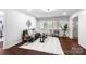 Inviting living room featuring dark wood floors, plenty of natural light, and a modern decorative style at 5428 Barnsdale Ln, Mint Hill, NC 28227