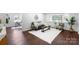 Cozy living room featuring stylish decor, including a black leather sofa at 5428 Barnsdale Ln, Mint Hill, NC 28227