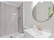Updated bathroom featuring a walk-in shower with modern tile, stylish vanity, and a round mirror at 565 Vine Arden Dr, Salisbury, NC 28146