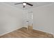 Neutral bedroom features a door to another room and wood-look floors at 565 Vine Arden Dr, Salisbury, NC 28146