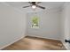 Bright bedroom features neutral paint, wood-look floors, a ceiling fan, and a window with green views at 565 Vine Arden Dr, Salisbury, NC 28146
