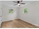 A neutral bedroom is bright and airy with wood-look floors, a ceiling fan, and views of nature at 565 Vine Arden Dr, Salisbury, NC 28146
