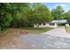 Exterior view of the home featuring a large driveway and mature trees at 565 Vine Arden Dr, Salisbury, NC 28146