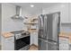 Modern kitchen featuring stainless steel appliances, butcher block countertops, and stylish white cabinets at 565 Vine Arden Dr, Salisbury, NC 28146
