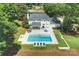 Aerial view of a beautifully landscaped home with a pool, patio, and well-manicured lawn at 5806 Bentway Dr, Charlotte, NC 28226