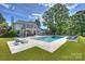 Beautiful backyard with pool, lounge chairs, and lush landscaping, creating a serene retreat at 5806 Bentway Dr, Charlotte, NC 28226