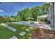 Backyard with a pool, putting green, a covered patio and ample green space at 5806 Bentway Dr, Charlotte, NC 28226