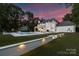 Backyard featuring swimming pool, manicured lawn, and outdoor entertainment space at 5806 Bentway Dr, Charlotte, NC 28226