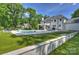Beautiful backyard with a sparkling pool, putting green, and meticulously maintained landscaping at 5806 Bentway Dr, Charlotte, NC 28226