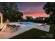 Backyard oasis featuring a stunning pool, water features, and ample seating at 5806 Bentway Dr, Charlotte, NC 28226