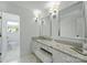 Bright bathroom featuring dual sinks, granite countertops, and ample storage space at 5806 Bentway Dr, Charlotte, NC 28226