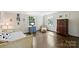 Cozy bedroom with hardwood floors, cheerful decorations, and a comfortable chair perfect for relaxing at 5806 Bentway Dr, Charlotte, NC 28226