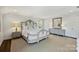 Bright bedroom with a luxurious bed, dresser, and matching side tables, offering a relaxing retreat at 5806 Bentway Dr, Charlotte, NC 28226