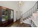 Elegant foyer with hardwood floors, ornate staircase, and chandelier at 5806 Bentway Dr, Charlotte, NC 28226