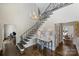 Grand foyer with a wrought iron staircase, chandelier, and hardwood floors at 5806 Bentway Dr, Charlotte, NC 28226
