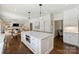 Open-concept kitchen with large center island and seating flows into the dining and living areas at 5806 Bentway Dr, Charlotte, NC 28226