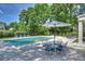 Relaxing pool area with a lounge area and a table with chairs for outdoor entertaining at 5806 Bentway Dr, Charlotte, NC 28226