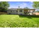Spacious backyard featuring a well maintained lawn and covered patio at 6100 Ashcrest Dr, Charlotte, NC 28217