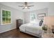 Bright bedroom with hardwood floors, a ceiling fan, and natural light from the large windows at 6100 Ashcrest Dr, Charlotte, NC 28217