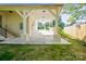 Attached carport featuring a concrete floor, bright lighting, and brick pillars at 6100 Ashcrest Dr, Charlotte, NC 28217