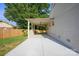 Spacious covered carport showing concrete floors and access to the home at 6100 Ashcrest Dr, Charlotte, NC 28217