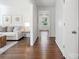 Hallway with hardwood floors and natural light, connecting the living spaces at 6100 Ashcrest Dr, Charlotte, NC 28217