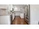Well-lit kitchen with stainless steel appliances, white cabinetry, a subway tile backsplash, and a functional center island at 6100 Ashcrest Dr, Charlotte, NC 28217