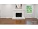 Bright living area with brick fireplace and neutral color palette at 6100 Ashcrest Dr, Charlotte, NC 28217