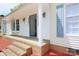 Inviting home entrance with brick steps and updated lighting, offering a warm and welcoming feel at 6124 Coach Hill Ln, Charlotte, NC 28212