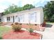 A well-maintained home with traditional siding, complemented by colorful landscaping and brick accents at 6124 Coach Hill Ln, Charlotte, NC 28212