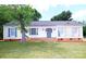 Charming one-story home featuring a well-maintained lawn, classic shutters, and a welcoming front entrance at 6124 Coach Hill Ln, Charlotte, NC 28212