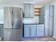 Updated kitchen featuring stainless steel refrigerator and ample cabinet space with modern hardware at 6124 Coach Hill Ln, Charlotte, NC 28212