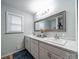 Bright bathroom featuring a double vanity, neutral walls and flooring, and minimalist decor at 6604 Plyler Mill Rd, Monroe, NC 28112