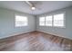Airy bedroom with lots of natural light, featuring new windows and wood flooring at 6604 Plyler Mill Rd, Monroe, NC 28112