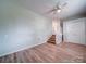 Spacious bedroom with hardwood floors, ceiling fan, and walk-in closet at 6604 Plyler Mill Rd, Monroe, NC 28112