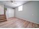 Spacious bedroom with hardwood floors, ceiling fan, and walk-in closet at 6604 Plyler Mill Rd, Monroe, NC 28112