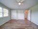 Bright bedroom with hardwood floors, ceiling fan, and double closets at 6604 Plyler Mill Rd, Monroe, NC 28112