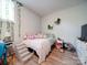 Cozy bedroom with decorative window vines, gray carpeting and minimalist decor at 6604 Plyler Mill Rd, Monroe, NC 28112