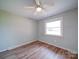 Bright bedroom with laminate floors, a ceiling fan, and natural light from a window at 6604 Plyler Mill Rd, Monroe, NC 28112