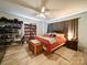 Inviting bedroom with a ceiling fan, bookcase and lots of toys and trinkets at 6604 Plyler Mill Rd, Monroe, NC 28112