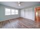 Bright bedroom with hardwood floors, ceiling fan, and double closets at 6604 Plyler Mill Rd, Monroe, NC 28112
