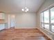 Bright dining area featuring wood floors, a modern light fixture, and natural light at 6604 Plyler Mill Rd, Monroe, NC 28112
